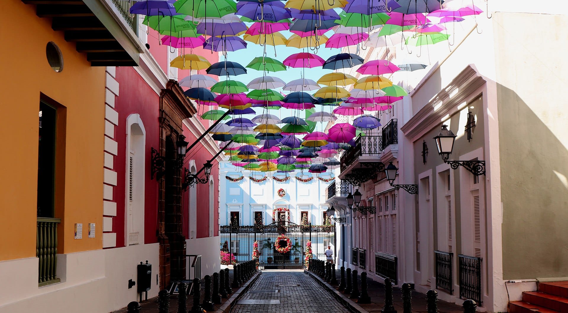 Friends of Dorothy walking the Calle Fortaleza umbrella street in Old San Juan during a cruise port day