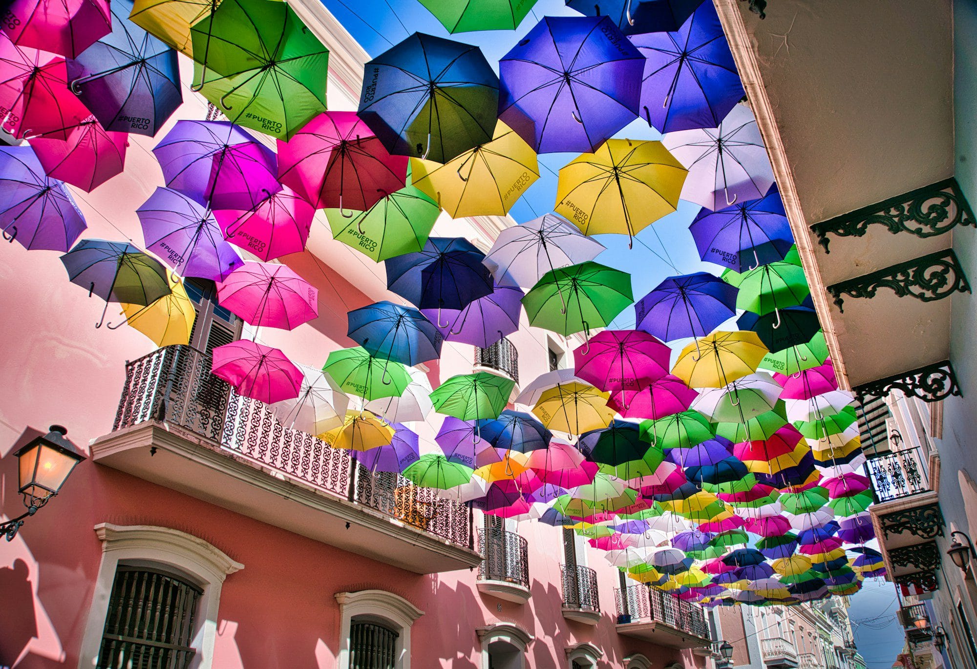 Colorful umbrellas hanging above Calle Fortaleza, Old San Juan, Puerto Rico