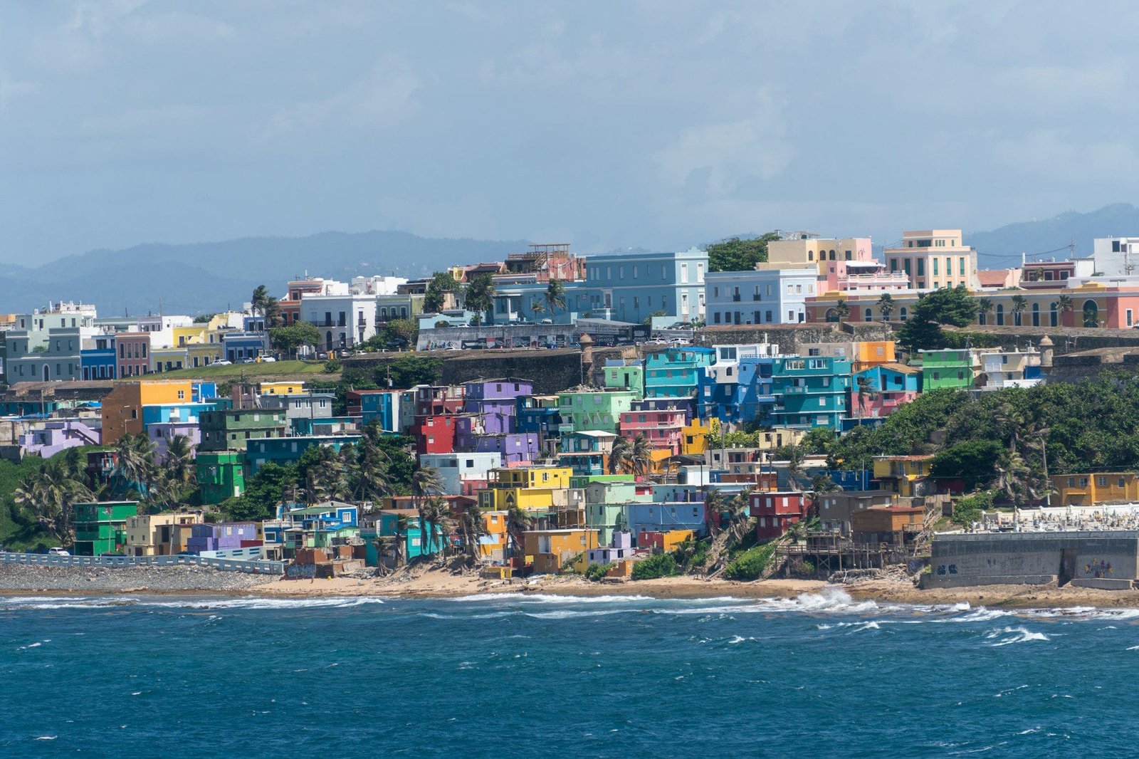 Colorful pastel houses lining a hillside street in Old San Juan, Puerto Rico
