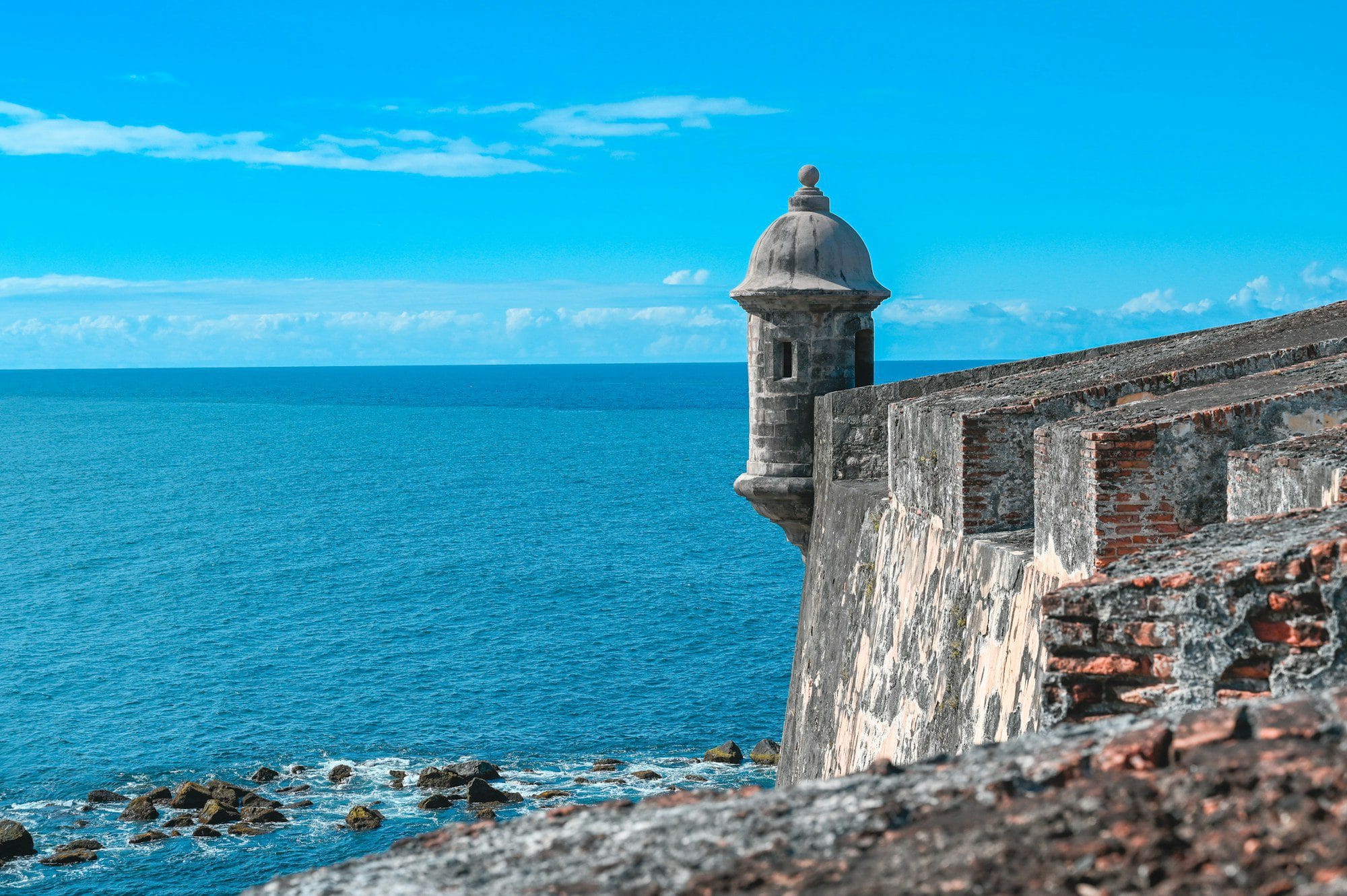 View of the San Juan, Puerto Rico waterfront and El Morro fortress wall from the sea — modern cruise port